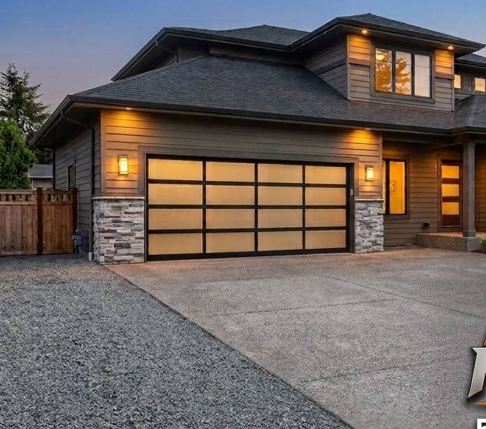 Modern home with an illuminated garage door